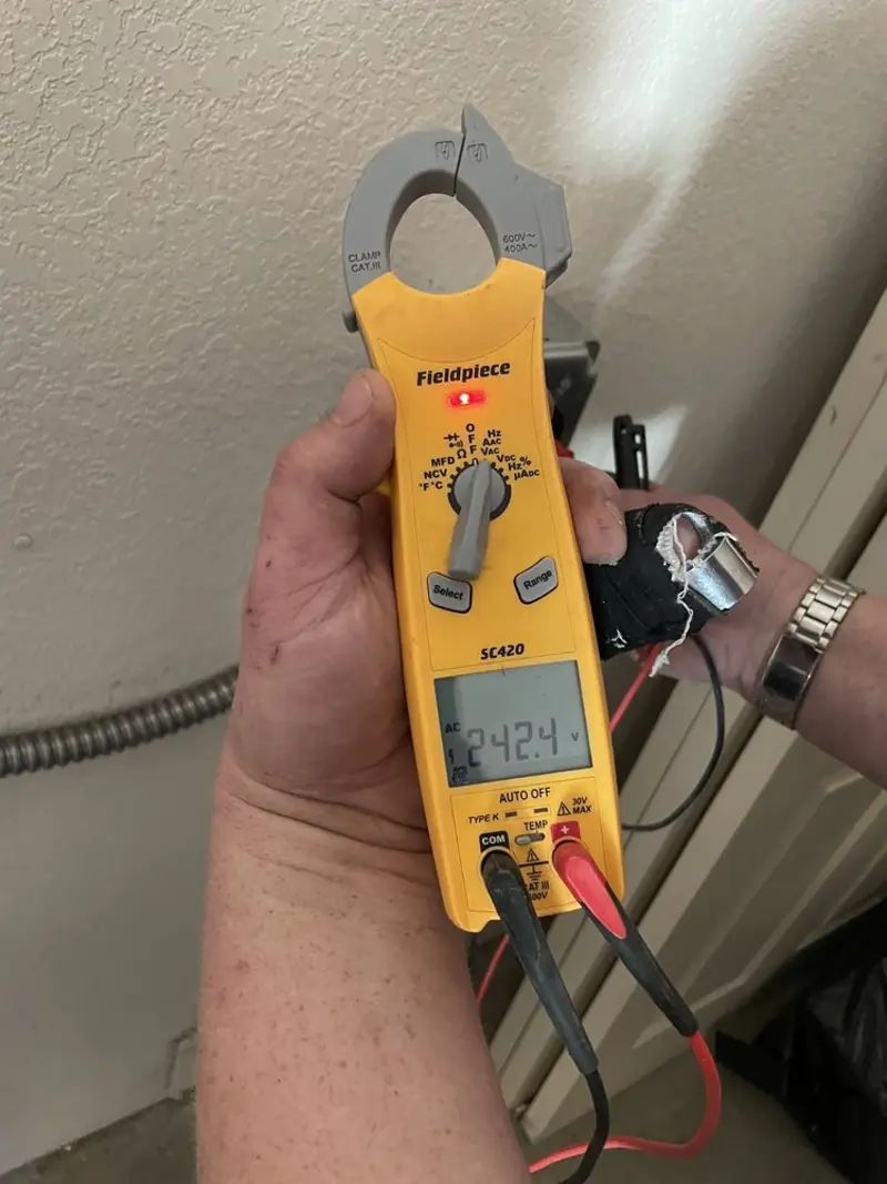 Voltage testing with clamp meter during Ceiling Fan Installation in Salida